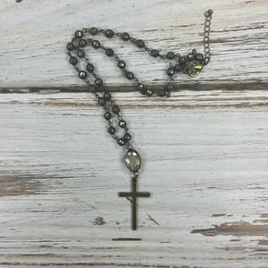 Handmade distressed metal necklace with cross pendant.